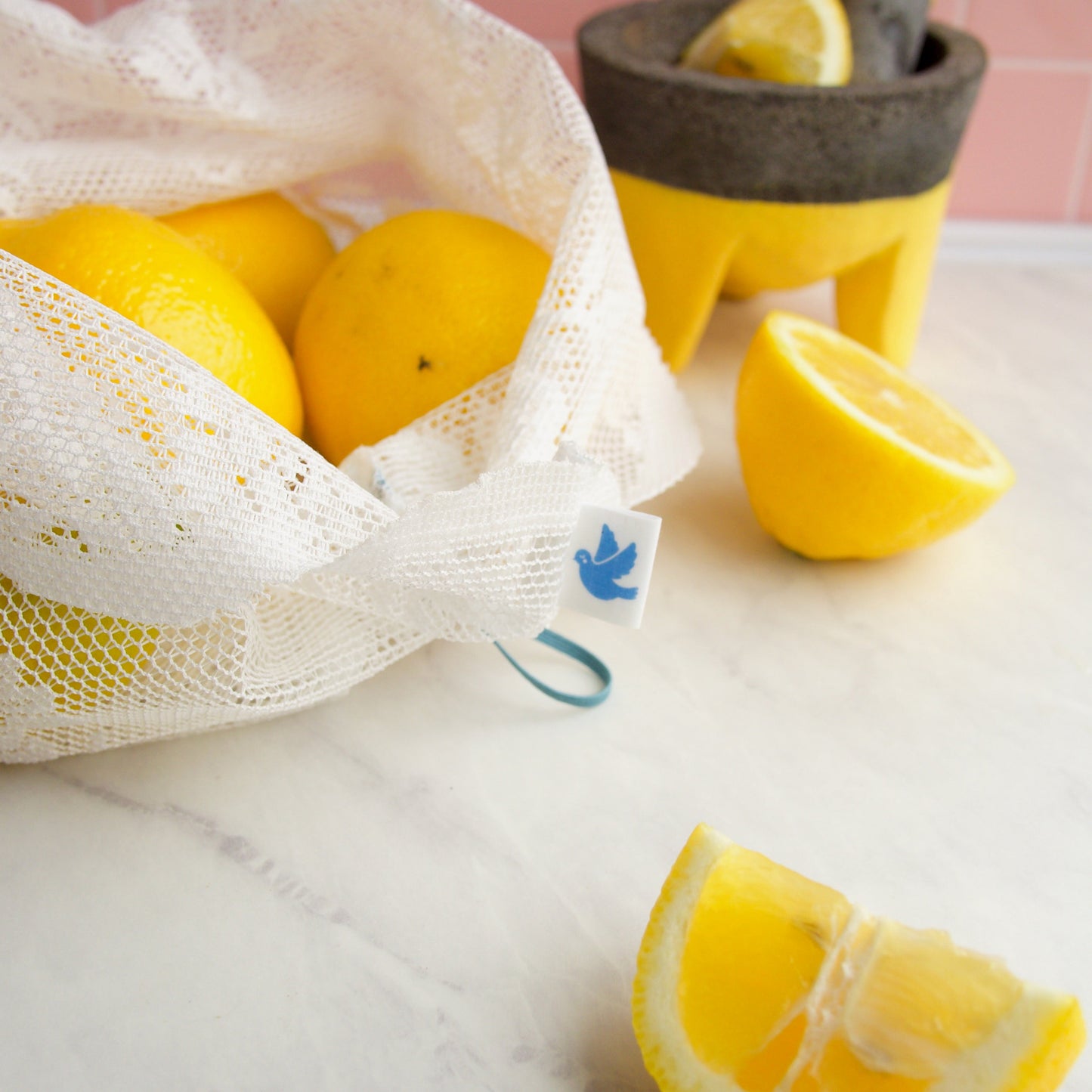 detail of reusable lace produce bag filled with lemons