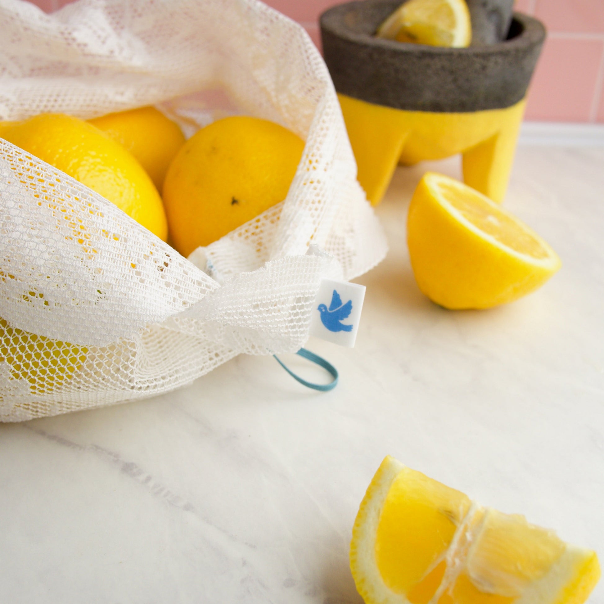 detail of reusable lace produce bag filled with lemons