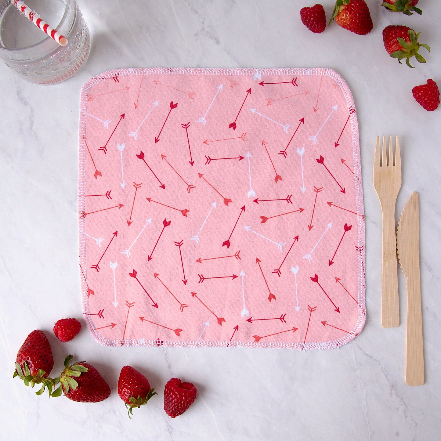 pink cloth napkins covered in red and white arrows 