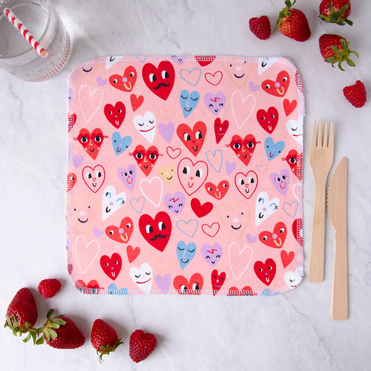 Cloth napkins covered in hearts with faces on them