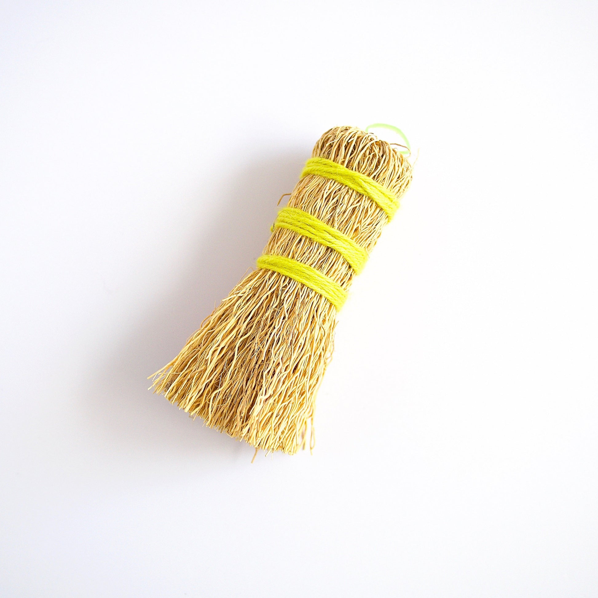 Escobeta de raiz Mexican dish scrubber made from plant roots wrapped in yellow wool yarn